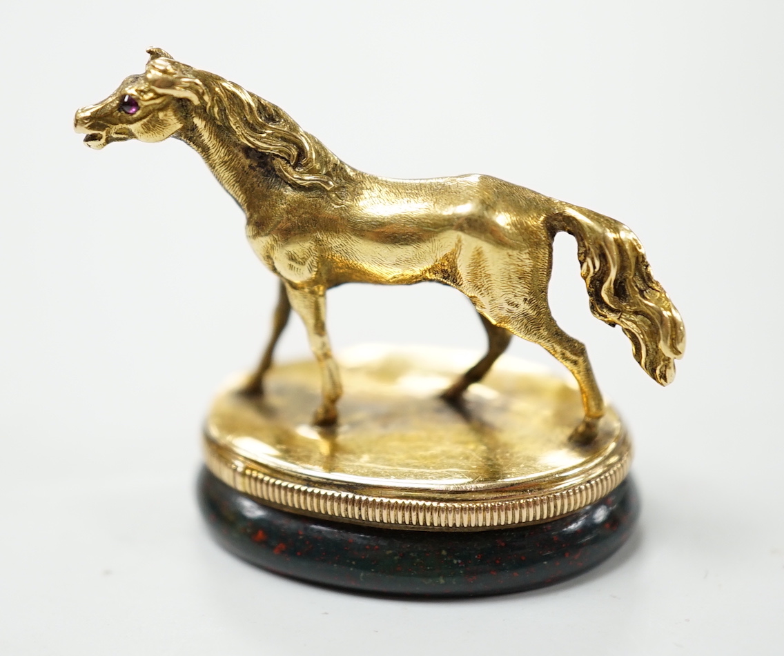 An early 20th century yellow metal and bloodstone set seal, with horse surmount